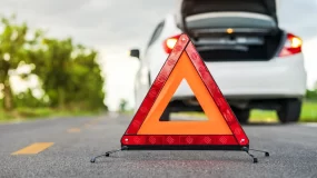car pulled over with hazard sign.