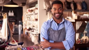 african american man smiling in front of business