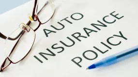 Home Insurance policy with eye glasses on top.