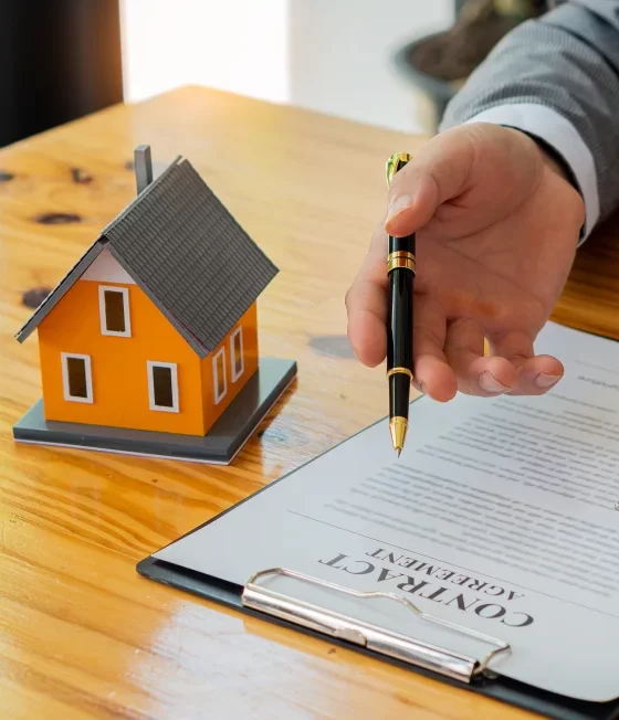 Couple hugging, looking at their home, thinking of homeowners insurance