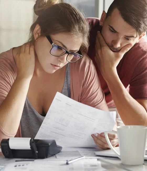 Worried couple about the dangers of going without liability insurance.