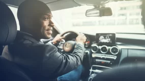 african american man driving car