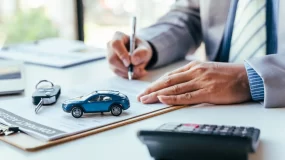 business owner signing commercial auto insurance policy