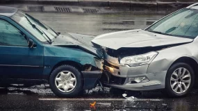 Woman looking at damage on car