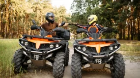ATV riders fist bump on a trail in Georgia.