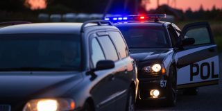 Police car pulled up behind another car - car insurance in Georgia
