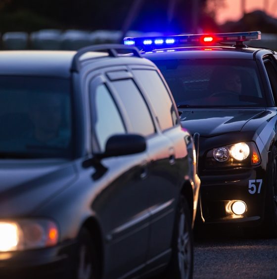 Police car pulled up behind another car - car insurance in Georgia