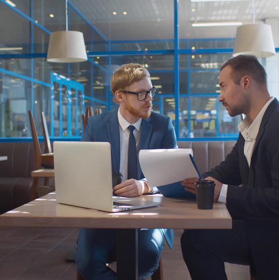 Two new business owners look over possible business insurance options in their restaurant - business insurance in Georgia