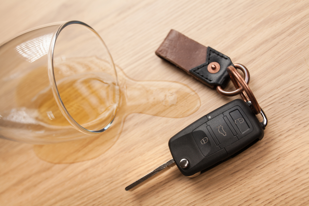 car keys next to a spilled alcoholic drink
